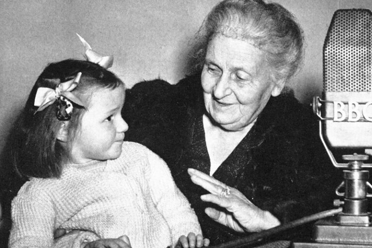 Maria Montessori standing with a girl