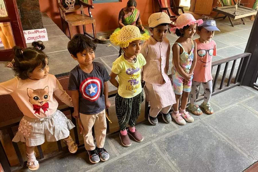 Children posing and learning in Model Village, Bengaluru during a field trip organized for children by Olivia Montessori
