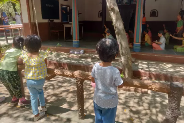 Children looking at a model of old school or Gurukul way of learning in Model Village, Bengaluru during a field trip organized for children by Olivia Montessori