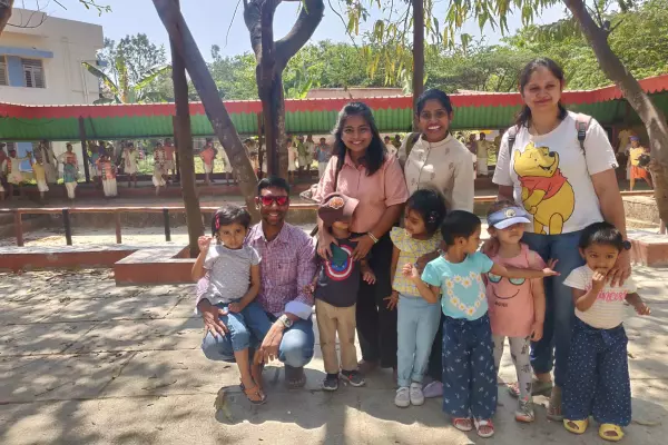 Parents posing in Model Village, Bengaluru during a field trip organized for children by Olivia Montessori