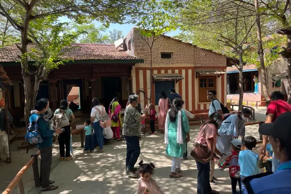 Parents having an enjoyable time with their children in Model Village, Bengaluru during a field trip organized for children by Olivia Montessori